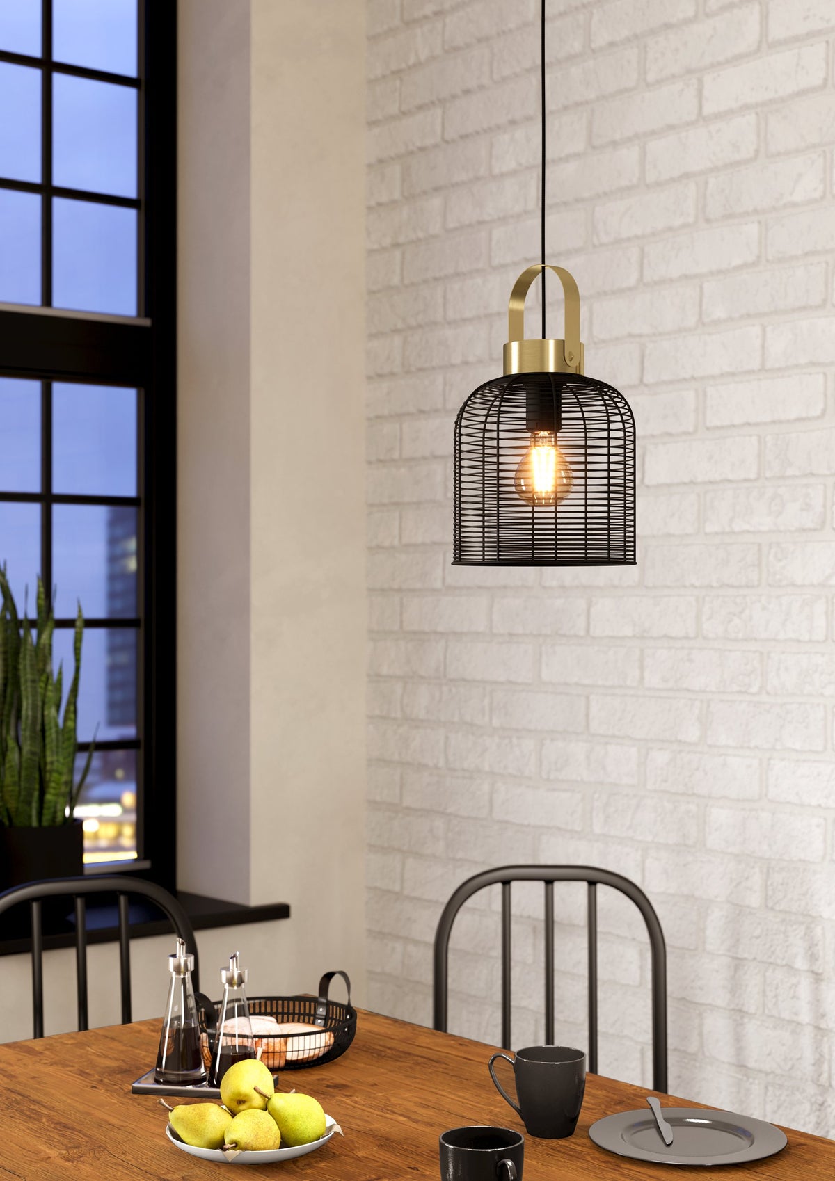 Lámpara colgante Arion sobre mesa de comedor junto a muro de ladrillo